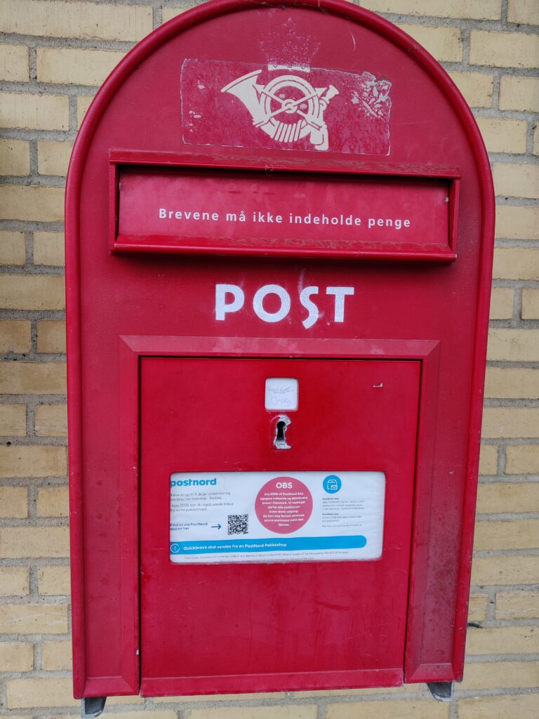 A battered Danish postbox